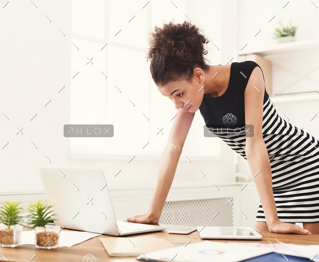 demo-attachment-422-business-woman-working-on-laptop-at-office-PRFJKQJ